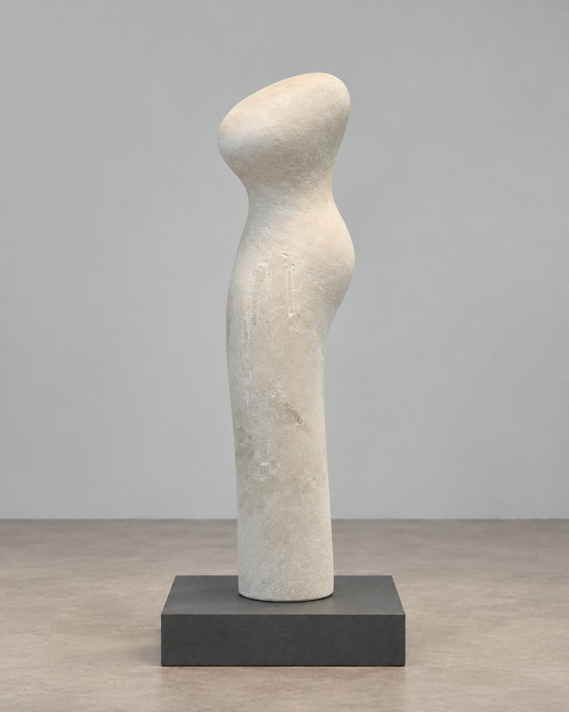 A Little Higher: a small pale marble figure with a rounded, leaning head, on a dark display plinth